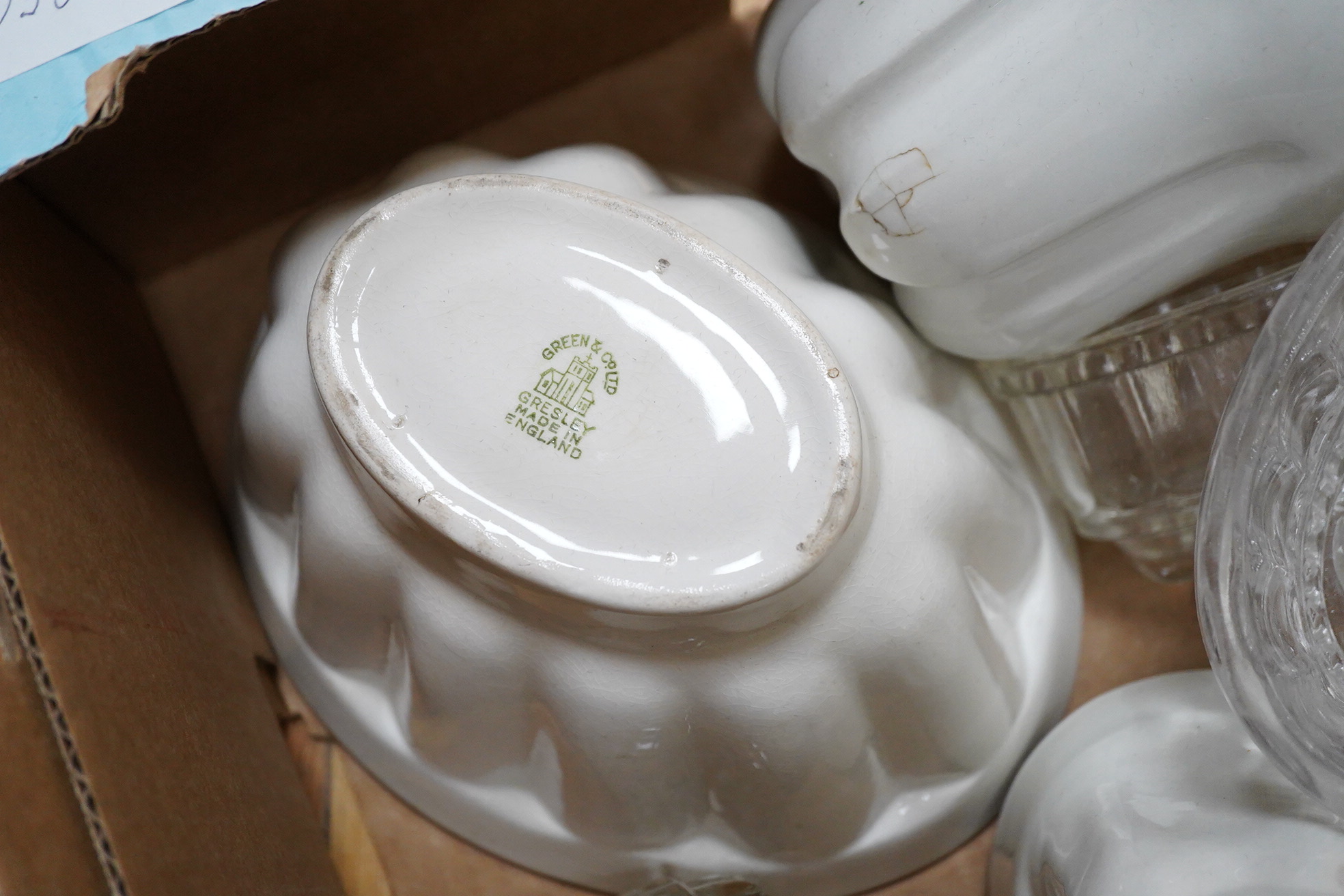A collection of mostly Victorian ceramic and later glass and metal jelly moulds